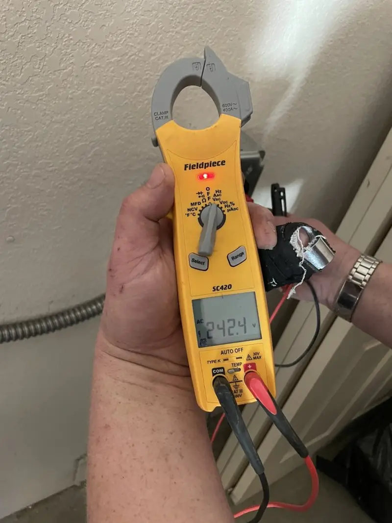 Voltage testing with clamp meter during Electrical Installation Services in East Greenwich